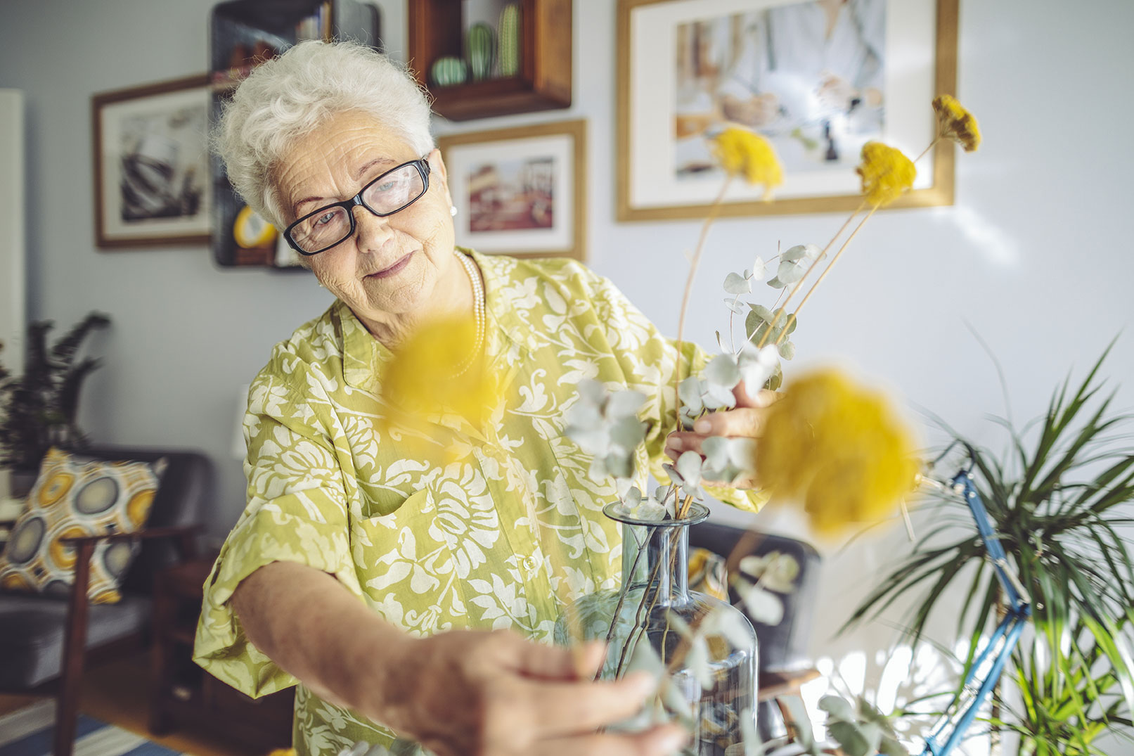 Older woman rearranges flowers